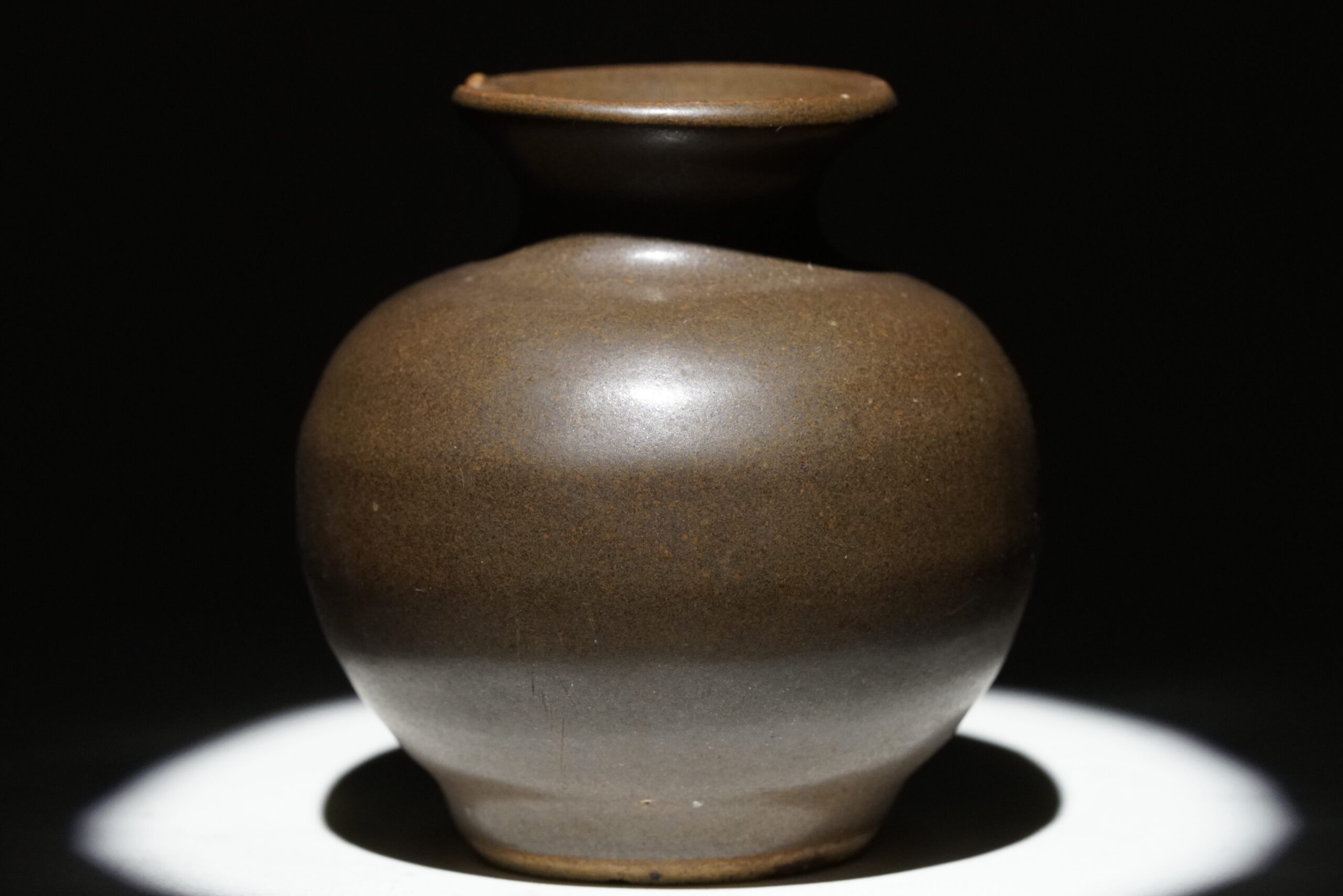 A rich brown ceramic bottle from China, dating back to the 11-1200s.