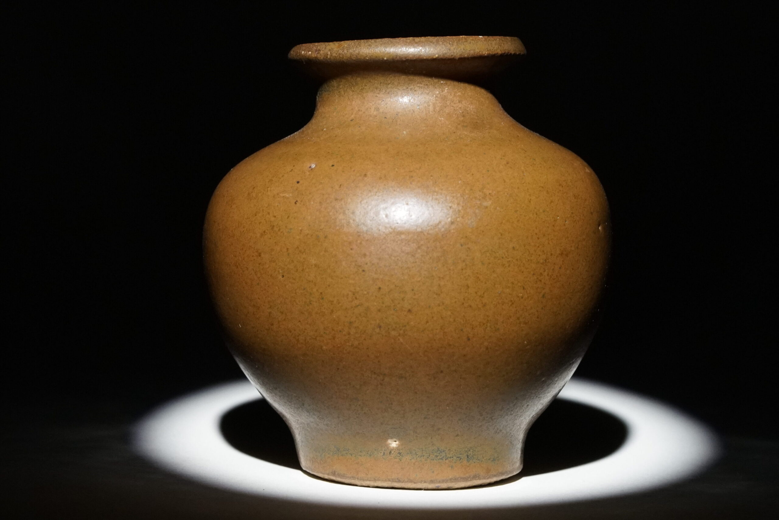 A golden brown ceramic bottle from China, dating back to the 11-1200s.